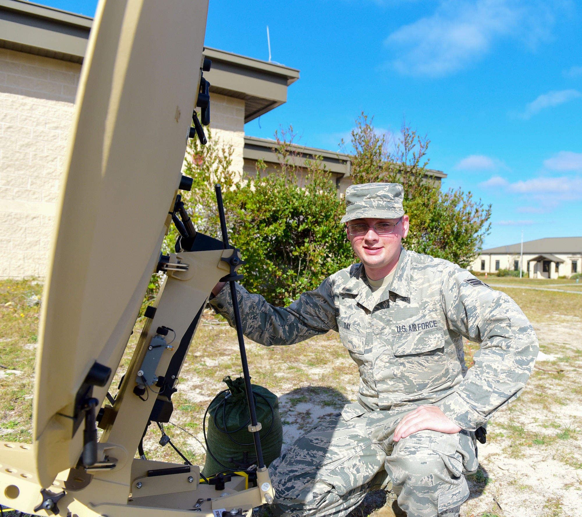 Senior Airman Jason Day, 325th Communications Squadron radio frequency transmission systems journeyman, sits next to a Communications Flyaway Kit at Tyndall Air Force Base, Fla., Dec. 11, 2018. Radio frequency transmission systems technicians usually install and maintain radio frequency communications systems at their installation. This includes the responsibility of deploying, sustaining, troubleshooting and repairing a vast variety of communications devices to ensure our ability to communicate. (U.S. Air Force photo by Senior Airman Cody R. Miller)