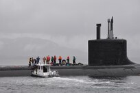 A small boat operated by Naval Surface Warfare Center, Carderock Division's Southeast Alaska Acoustic Measurement Facility (SEAFAC) delivers Sailors and trial directors to Virginia-class fast-attack submarine USS Texas (SSN 775) on Oct. 26, 2018, as it sits surfaced in the SEAFAC Static Site off the coast of Ketchikan, Alaska. (U.S. Navy photo by Kelley Stirling/Released)
