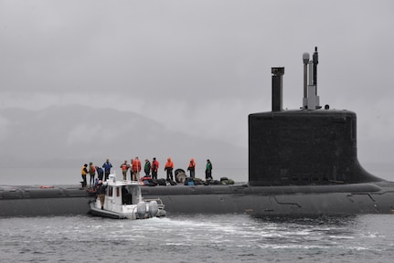 A small boat operated by Naval Surface Warfare Center, Carderock Division's Southeast Alaska Acoustic Measurement Facility (SEAFAC) delivers Sailors and trial directors to Virginia-class fast-attack submarine USS Texas (SSN 775) on Oct. 26, 2018, as it sits surfaced in the SEAFAC Static Site off the coast of Ketchikan, Alaska. (U.S. Navy photo by Kelley Stirling/Released)