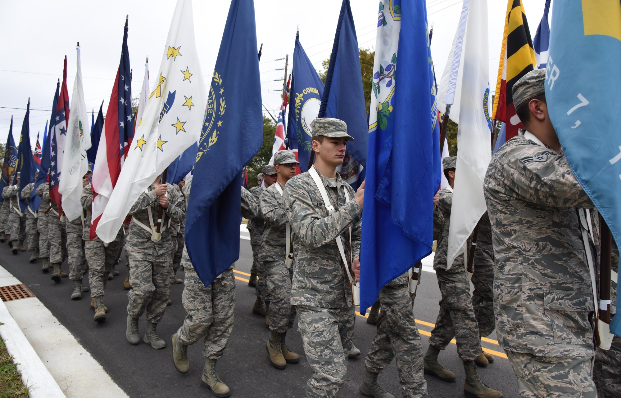 Airmen from the 81st Training Group carry the 50 state flags in the Ocean Springs Christmas Parade in Ocean Springs, Mississippi, Dec. 9, 2018. The Keesler Honor Guard also participated in the event. (U.S. Air Force photo by Kemberly Groue)