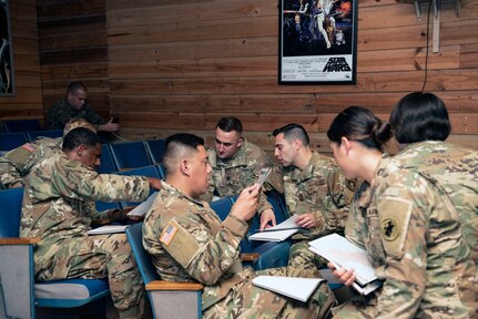 Joint Task Force-Bravo (JTF-Bravo) service members discuss a class activity during a Joint Humanitarian Operations Course at Soto Cano Air Base (SCAB), Honduras, Dec. 3, 2018.