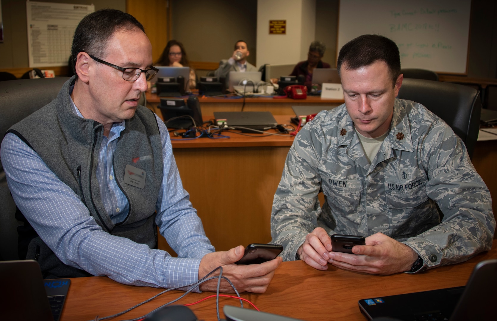 Don Ryan (left), a representative of the company that developed the app, teaches Maj. Samuel Owen (right), physician, how to use the secure messaging app at Brooke Army Medical Center at Joint Base San Antonio-Fort Sam Houston Dec. 4. The app, which is Health Insurance Portability and Accountability Act compliant, will allow BAMC staff members to share patient information and photos securely.