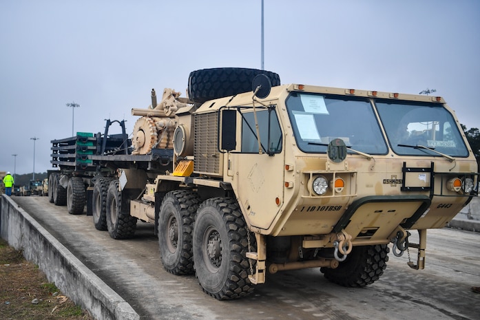 A Soldier from the 1st Infantry Division drives a military vehicle off a train during a vehicle offload Dec. 10, 2018, at Joint Base Charleston, S.C.