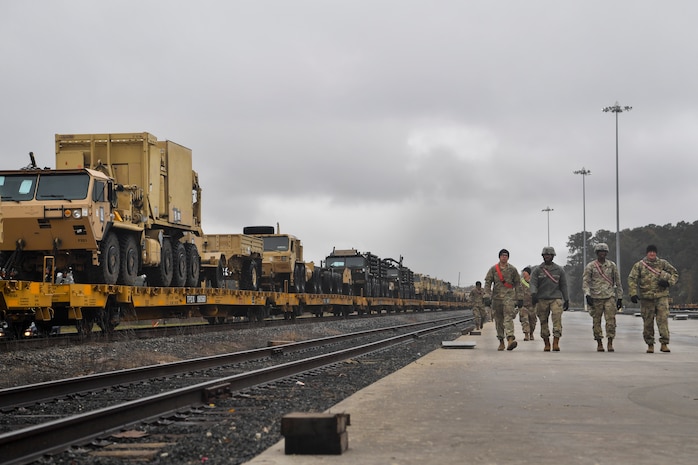 Soldiers from the 1st Infantry Division get in place to unload military vehicles Dec. 10, 2018, at Joint Base Charleston, S.C.