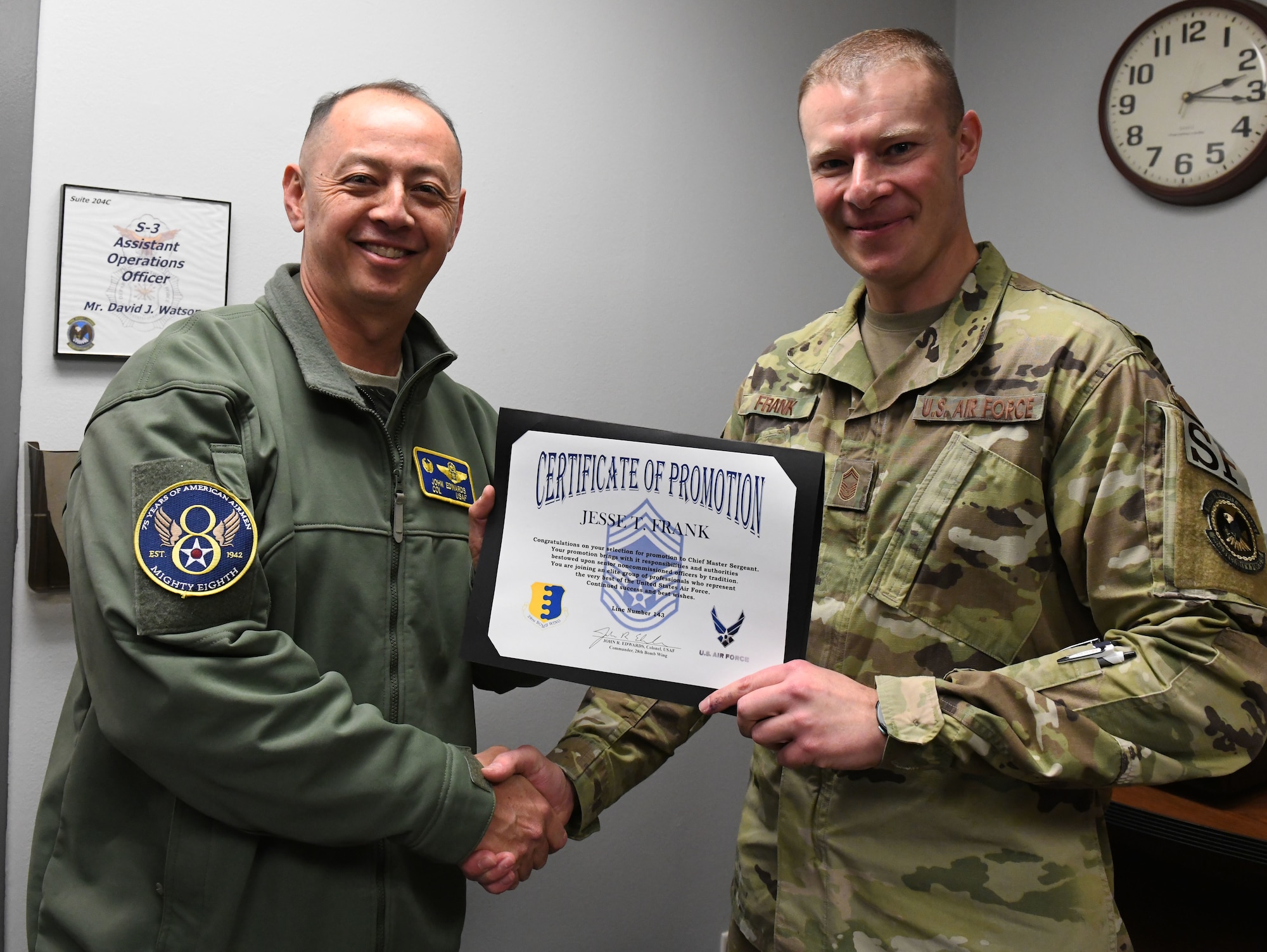 Col. John Edwards, the 28th Bomb Wing commander, presents a certificate of promotion to Senior Master Sgt. Jesse Frank, the 28th Security Forces Squadron operations superintendent, at Ellsworth Air Force Base, S.D., Dec. 4, 2018. Frank was selected for the rank of chief master sergeant during promtion cycle 18E9. Out of the elegable 2,241 sergeants across the Air Force that were eligible for the rank, only 479 were selected. (U.S. Air Force photo by Airman 1st Class Thomas Karol)