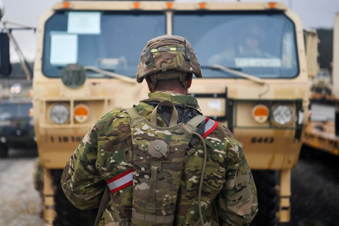 A Soldier from the 1st Infantry Division guides a vehicle off a train Dec. 10, 2018, at Joint Base Charleston, S.C.