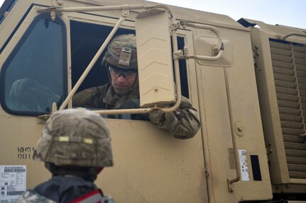 A Soldier from the 1st Infantry Division gives directions during a vehicle offload, Dec. 10, 2018, at Joint Base Charleston, S.C.