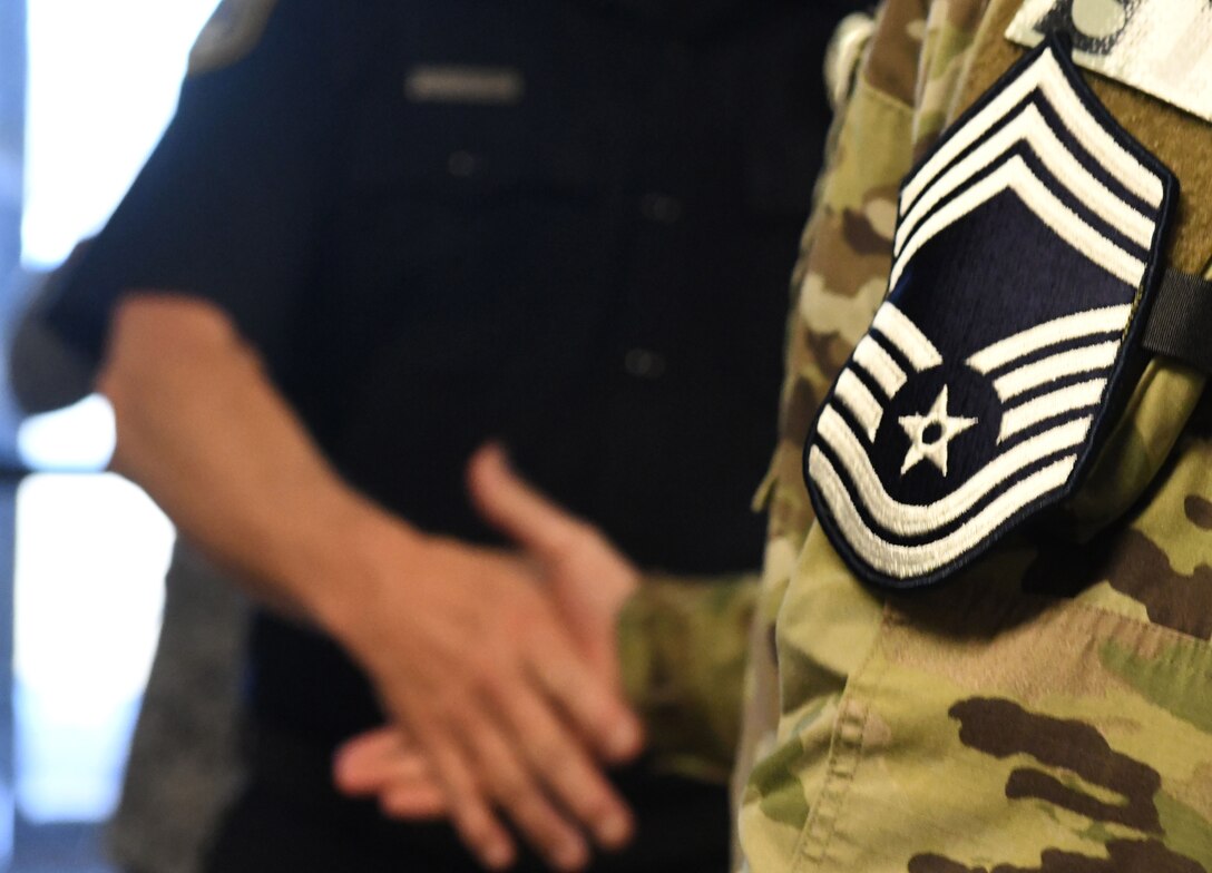 Senior Master Sgt. Jesse Frank, the 28th Security Forces Squadron operations superintendent, shakes hands with Dave Watson, the 28th SFS assistant operations superintendent, at Ellsworth Air Force Base, S.D., Dec. 4, 2018. Base leadership and 28th Bomb Wing chief master sergeants traveled to the 28th SFS to inform Frank that he’d been selected for the rank of chief master sergeant. (U.S. Air Force photo by Airman 1st Class Thomas Karol)