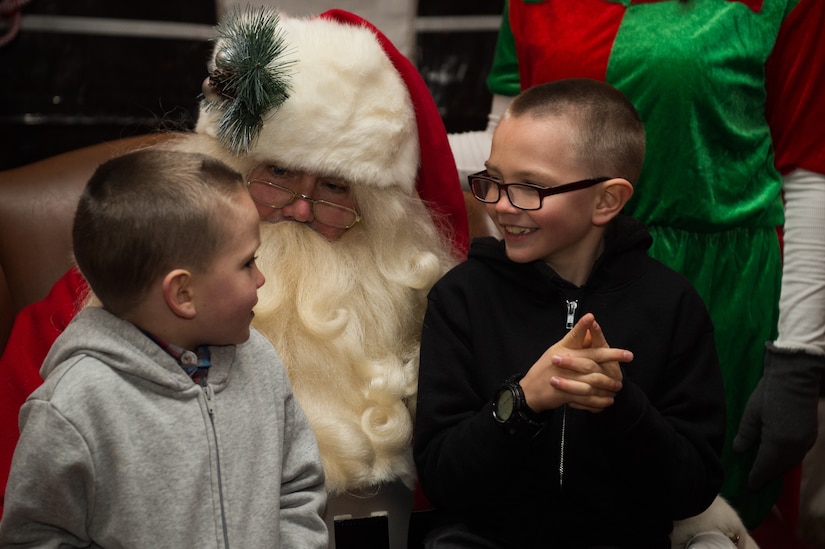 (Left) Evan and (right) Trevor Horacek, sons of U.S. Army Pfc. Andrew Horacek, 149th Seaport Operation Company, 10th Battalion, 7th Transportation Brigade (Expeditionary) cargo specialist, talk to Santa Clause after the Holiday Tree Lighting ceremony at Fort Eustis, Virginia, Dec. 7, 2018.