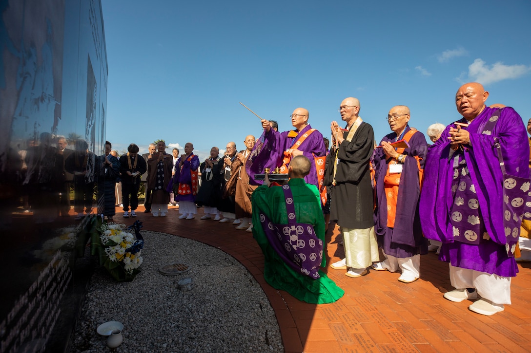 Members of the Japanese Religious Committee for World Federation pray over the Pacific War Memorial during their visit to Marine Corps Base Hawaii, Dec. 7, 2018. The group annually visits the base to offer prayers and respects at the Pacific War Memorial, the Klipper Memorial and the Japanese Lt. Fusata Iida crash site marker. (U.S. Marine Corps photo by Sgt. Zachary Orr)