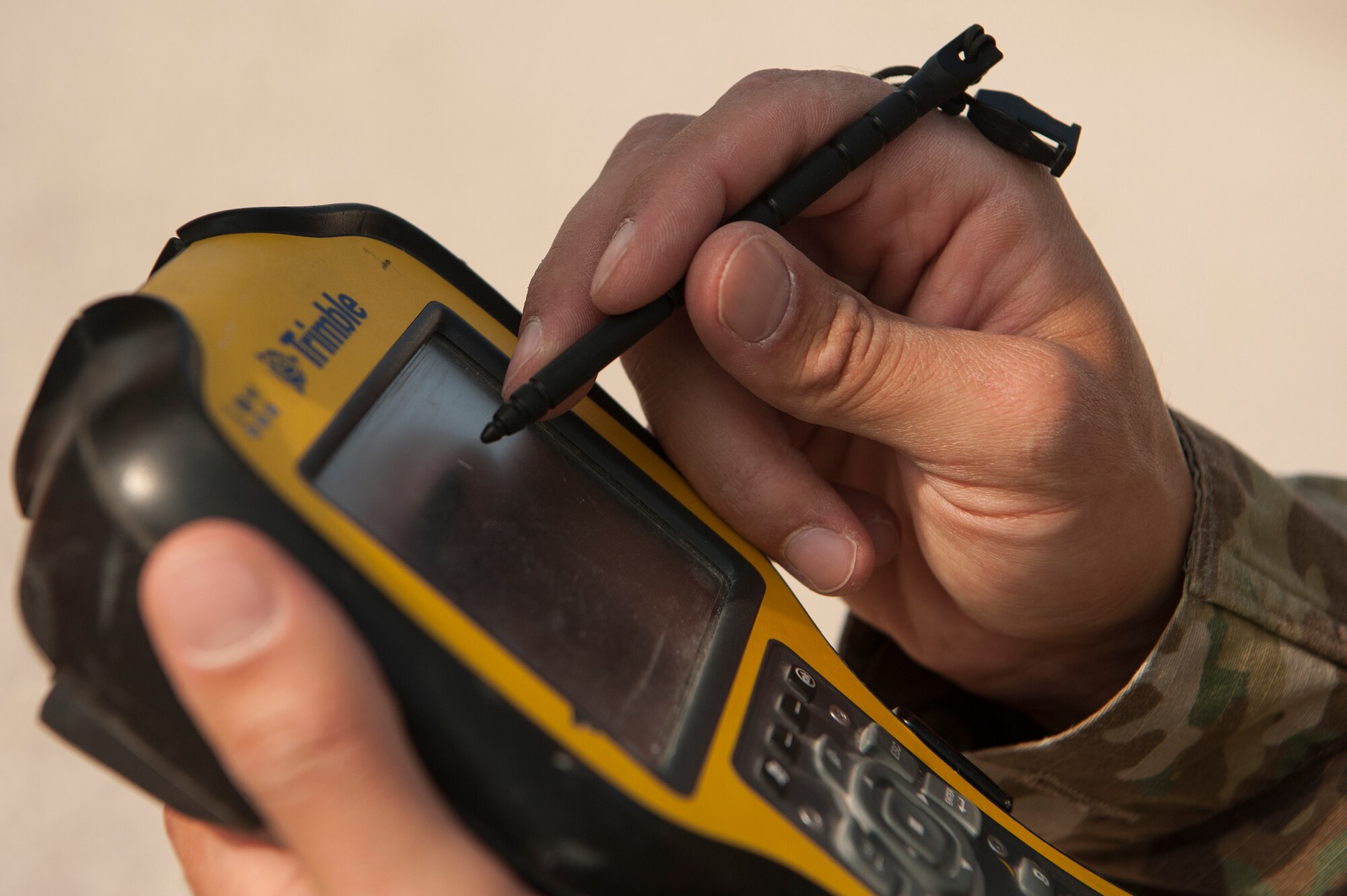 Staff Sgt. Arich Bosshart, 379th Expeditionary Civil Engineer Squadron geobase NCO in charge, tests surveying equipment Dec. 11, 2018, at Al Udeid Air Base, Qatar. Bosshart is responsible for creating and updating installation maps with the use of geospatial information system equipment and automated computer-aided design and drafting software. He also provides surveying support to construction that occurs on base. (U.S. Air Force photo by Tech. Sgt. Christopher Hubenthal)