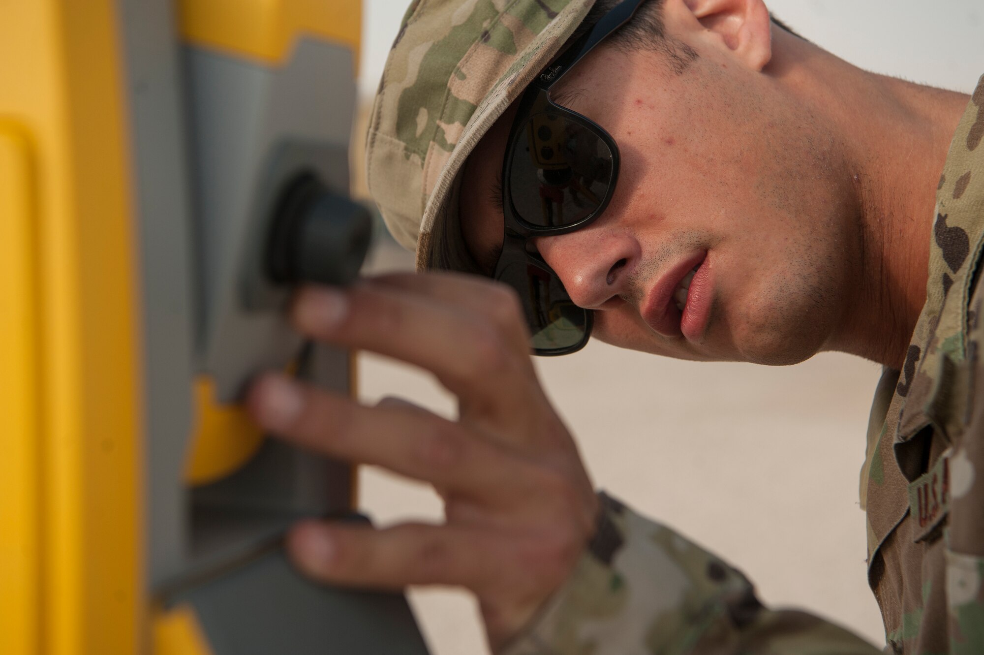 Staff Sgt. Arich Bosshart, 379th Expeditionary Civil Engineer Squadron geobase NCO in charge, tests surveying equipment Dec. 11, 2018, at Al Udeid Air Base, Qatar. Bosshart is responsible for creating and updating installation maps with the use of geospatial information system equipment and automated computer-aided design and drafting software. He also provides surveying support to construction that occurs on Al Udeid. (U.S. Air Force photo by Tech. Sgt. Christopher Hubenthal)