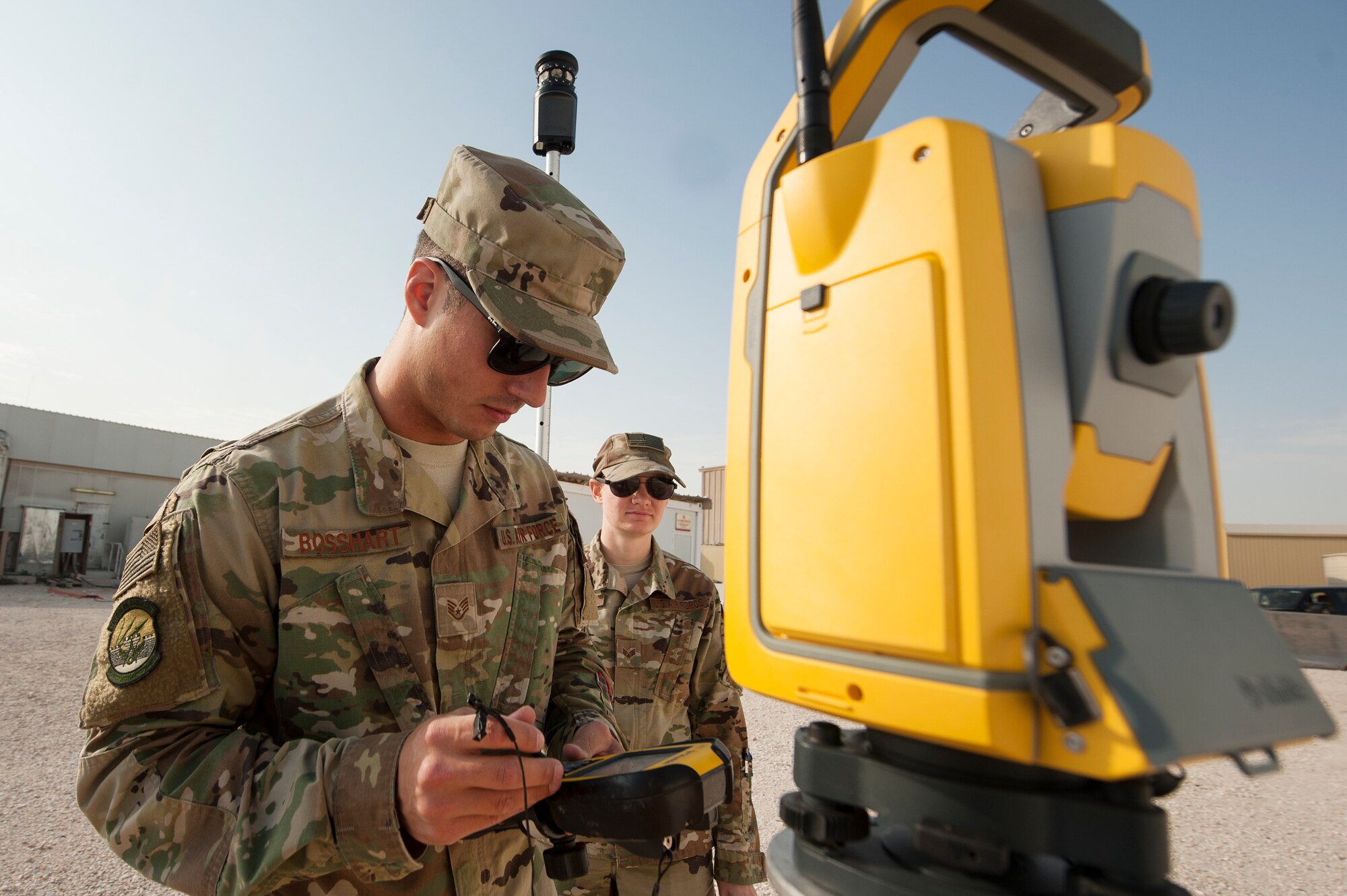Staff Sgt. Arich Bosshart, 379th Expeditionary Civil Engineer Squadron geobase NCO in charge, and Senior Airman Jessica Kraus, 379th ECES geobase technician, conduct an operations check on GPS surveying equipment Dec. 11, 2018, at Al Udeid Air Base, Qatar. Bosshart and Kraus are responsible for creating and updating installation maps with the use of geospatial information system equipment and automated computer-aided design and drafting software. They also provide surveying support to construction that occurs on Al Udeid. (U.S. Air Force photo by Tech. Sgt. Christopher Hubenthal)