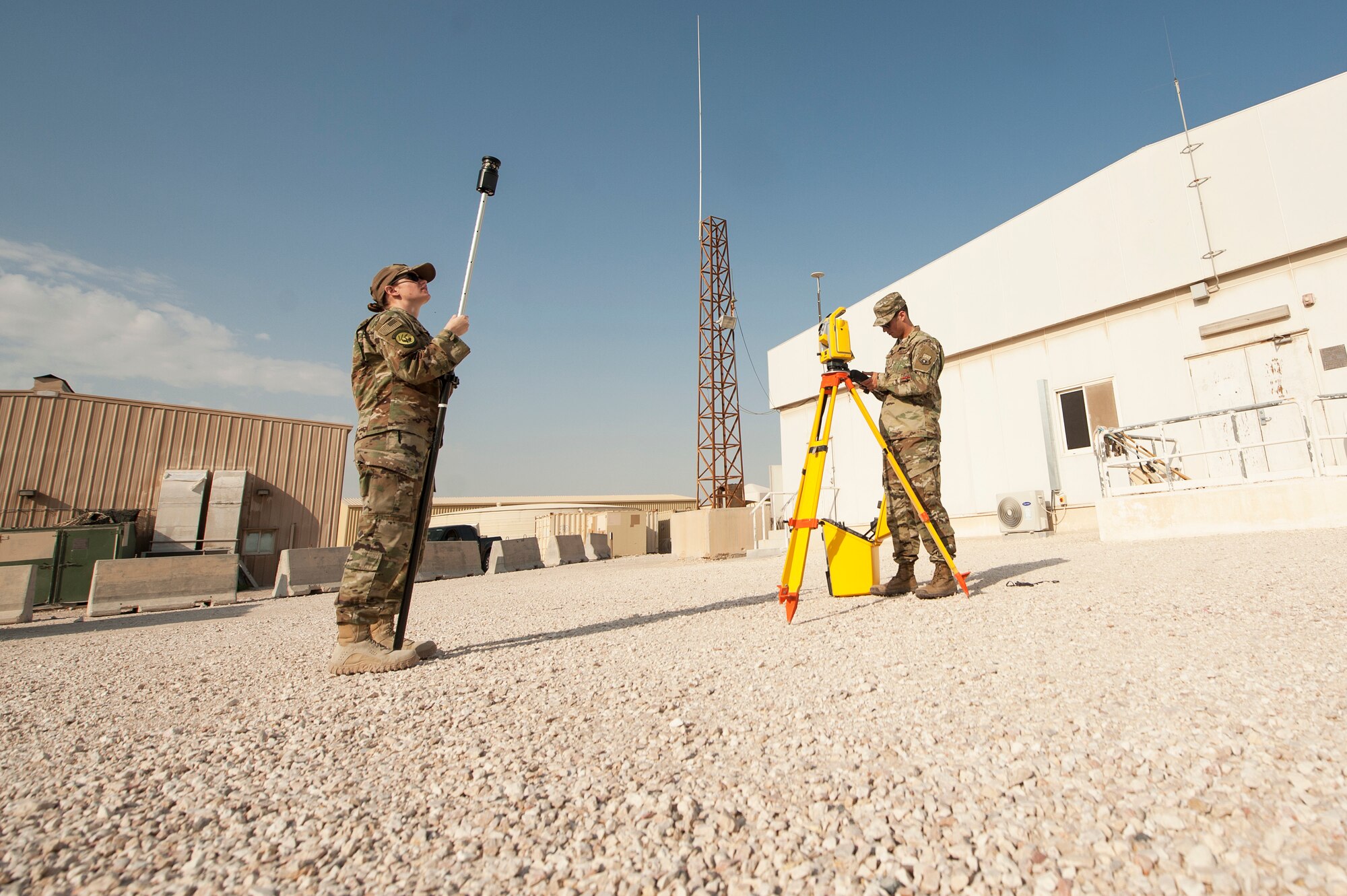 Staff Sgt. Arich Bosshart, 379th Expeditionary Civil Engineer Squadron geobase NCO in charge, and Senior Airman Jessica Kraus, 379th ECES geobase technician, test the pairing of GPS surveying equipment as part of an operations check Dec. 11, 2018, at Al Udeid Air Base, Qatar. Bosshart and Kraus are responsible for creating and updating installation maps with the use of geospatial information system equipment and automated computer-aided design and drafting software. They also provide surveying support to construction that occurs on Al Udeid. (U.S. Air Force photo by Tech. Sgt. Christopher Hubenthal)