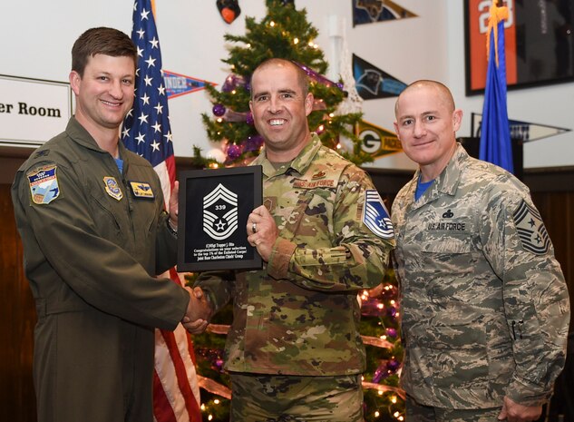 Col. Clint ZumBrunnen, 437th Airlift Wing commander, left, and Chief Master Sgt. Ronnie Phillips, 437th AW command chief, right, congratulate chief select, Senior Master Sgt. Trapper Otto, 437th Maintenance Squadron flight superintendent, during a release party held Dec. 7, 2018 at Joint Base Charleston, S.C. Chief master sergeant is the highest enlisted rank in the Air Force and is held by one percent of the enlisted force.