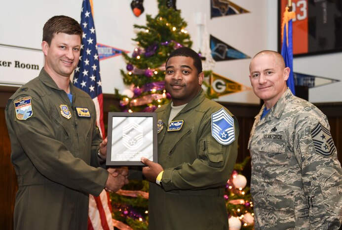 Col. Clint ZumBrunnen, 437th Airlift Wing commander, left, and Chief Master Sgt. Ronnie Phillips, 437th AW command chief, right, congratulate chief select, Senior Master Sgt. Lacario Tufts, 14th Airlift Squadron flight superintendent, during a release party held Dec. 7, 2018, Joint Base Charleston, S.C. A release party was held in their honor at the Charleston Club, where base members gathered in support and celebration.