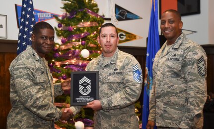 Col. Adam Terrence, 628th Air Base Wing commander, left, and Chief Master Sgt. Michael Cole, 628th Air Base Wing command chief, right, congratulate chief select, Senior Master Sgt. Armando Chavez, 628th Logistics Readiness Squadron, flight superintendent, during a release party held Joint Base Charleston, S.C., Dec. 7, 2018.
