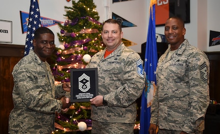 Col. Terrence Adams, 628th Air Base Wing commander, left, and Chief Master Sgt. Michael Cole, 628th Air Base Wing command chief, right, congratulate chief select, Senior Master Sgt.Patrick Hackman, 628th Communications Squadron operations flight superintendent, during a release party held Dec. 7, 2018, at Joint Base Charleston, S.C. A release party was held in their honor at the Charleston Club, where base members gathered in support and celebration.