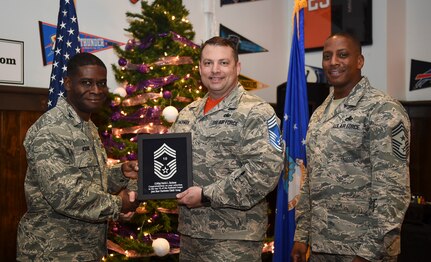 Col. Terrence Adams, 628th Air Base Wing commander, left, and Chief Master Sgt. Michael Cole, 628th Air Base Wing command chief, right, congratulate chief select, Senior Master Sgt.Patrick Hackman, 628th Communications Squadron operations flight superintendent, during a release party held Dec. 7, 2018, at Joint Base Charleston, S.C. A release party was held in their honor at the Charleston Club, where base members gathered in support and celebration.