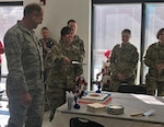 Spc. Ashley Hartman cuts the ceremonial birthday cake for the National Guard's 381st birthday alongside Nevada Adjutant General, Brig. Gen. William Burks, left. The Nevada National Guard Joint Forces Headquarters office celebrates the National Guard's birthday every year with the highest and most junior ranking members available as cake cutters.
