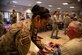 Staff Sgt. Jennifer Lopez, a 302nd Aeromedical Staging Squadron medical technician, takes the blood pressure of a reservist during the Air Force Reserve Command’s 302nd Airlift Wing December unit training assembly at Peterson Air Force Base, Colorado, Dec. 2, 2018.
