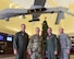 U.S. Air Force Col. Julian Cheater, 432nd Wing/432nd Air Expeditionary Wing commander (left), U.S. Army Lt. Gen. Paul Funk, III Armored Corps and Fort Hood, Texas, commanding general (second from the left), U.S. Air Force Col. Jim,  432nd  WG/432nd AEW vice commander (second from the right), and Chief Master Sgt. Jamie, 432nd  WG/432nd AEW command chief (right), stand under an MQ-1 Predator at Creech Air Force Base, Nevada, Dec. 10, 2018. Funk made a visit to Creech to thank the Remotely Piloted Aircraft Airmen who kept the Soldiers he led safe during Operation Inherent Resolve. (U.S. Air Force Photo by Airman 1st Class Haley Stevens)