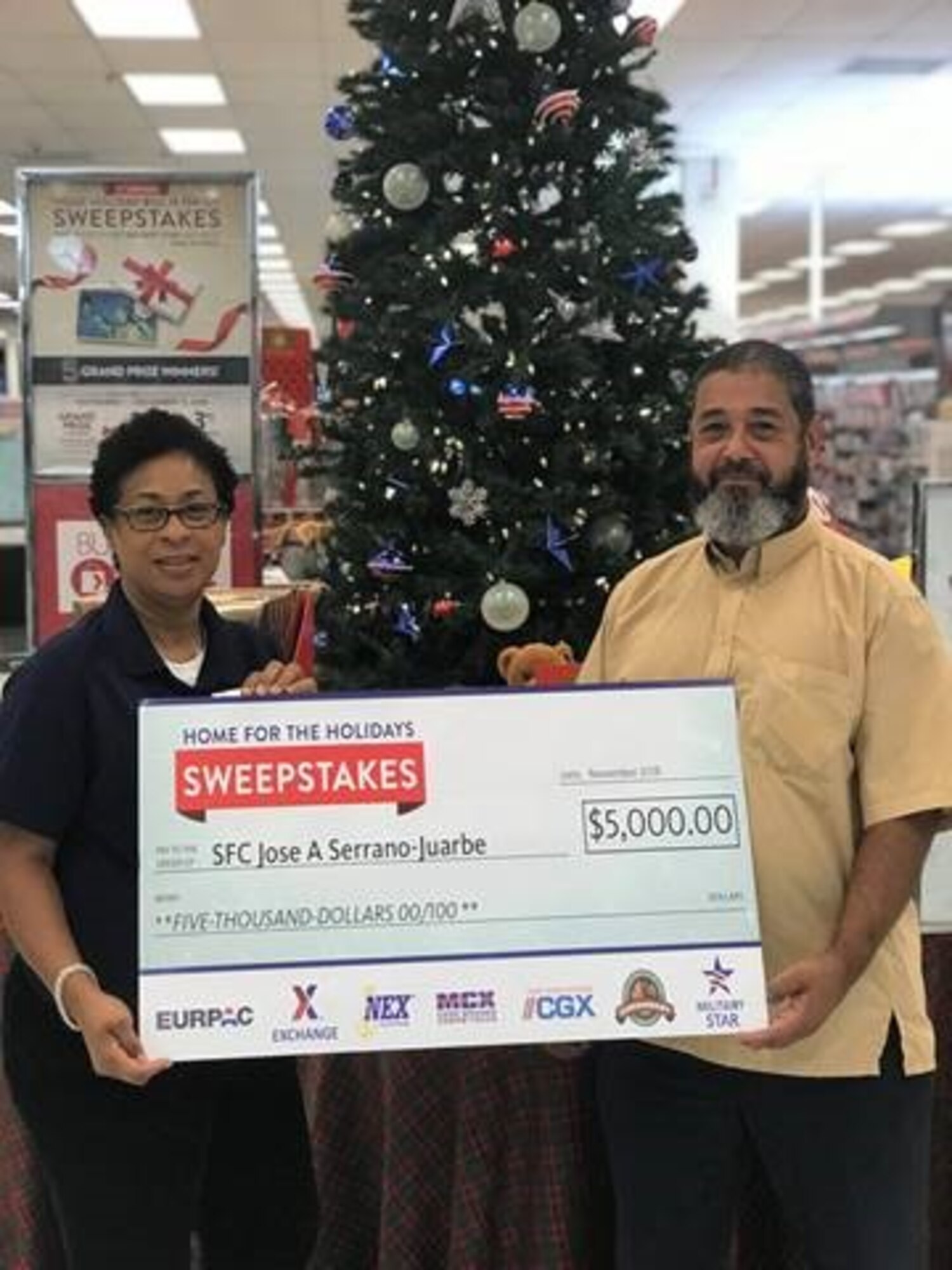 Retired U.S. Army Sgt. 1st Class Jose Serrano Juarbe accept at $5,000 check at MacDill Air Force Base, Fla., Dec. 10, 2018.