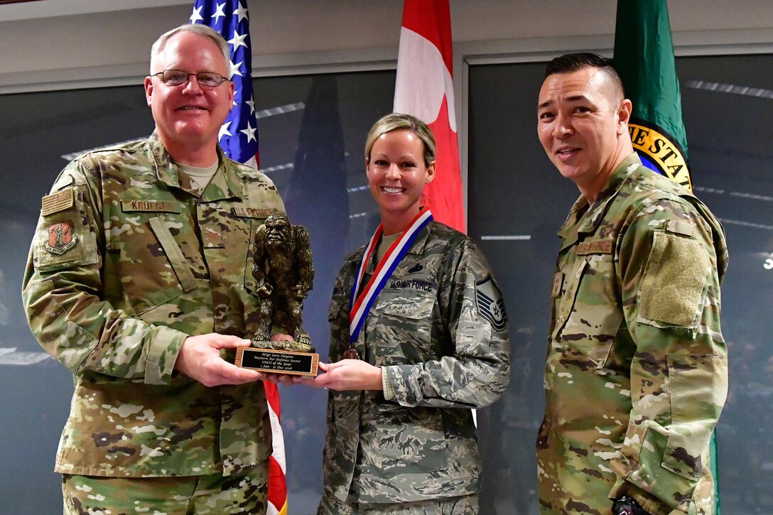 Master. Sgt. Sara Haynes, 225th Support Squadron NCOIC of logistics is named the Western Air Defense Sector SNCO of the Year Dec. 1, 2018 on Joint Base Lewis-McChord. Haynes poses with Col. William Krueger (left), 225th Air Defense Group commander and Chief Master Sgt. Allan Lawson, WADS senior enlisted leader .  (U.S. Air National Guard photo by Maj. Kimberly D. Burke)