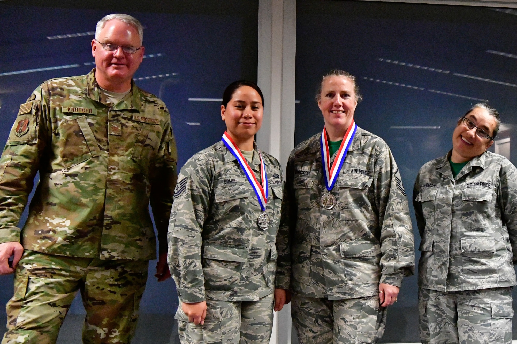 The 225th Air Defense Group command staff annual award winners pose with their Bigfoot trophies and medals Dec. 1, 2018 on Joint Base Lewis-McChord, Washington. Pictured from left to right are:  Col. William Krueger, 225th ADG commander; NCO of the Year Tech. Sgt. Jocelyn Somol, military personalist; SNCO of the Year Master Sgt. Malinda Gonnuscio, training manager; and  Senior Master Sgt. Rebekah St. Romain, 225th ADG superintendent. Not pictured are: Category I Civilian of the Year Richard Gonzales, military personelist; Category II Civilian of the Year Kimberly Burke, public affairs manager; and Drill Status Guardsmen Company Grade Officer Capt. Colette Muller, public affairs officer.  (U.S. Air National Guard photo by Maj. Kimberly D. Burke)