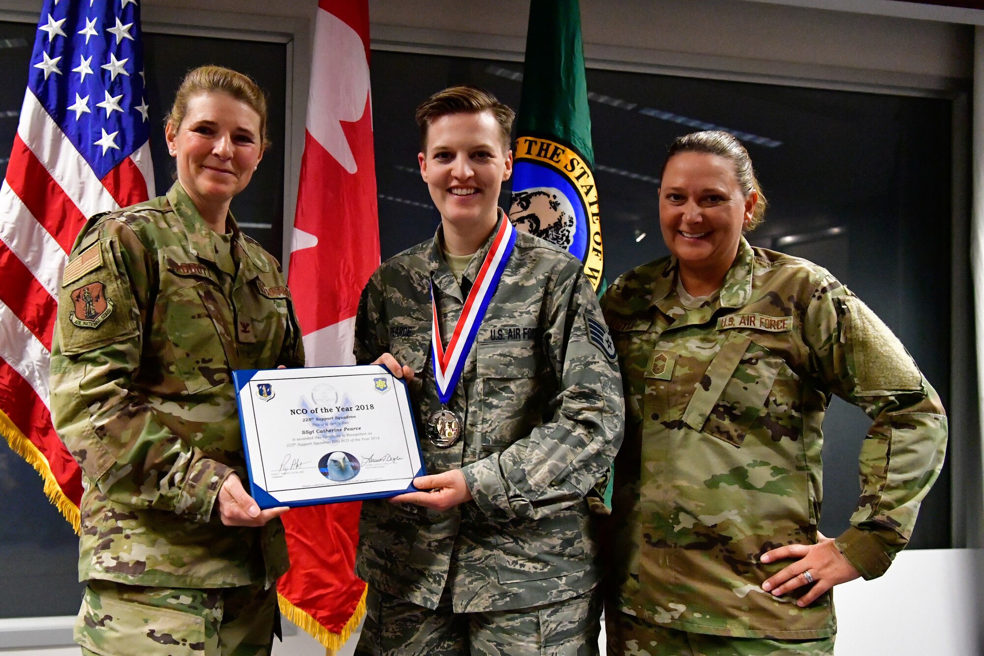 Staff Sgt. Catherine Pearce, 225th Support Squadron emergency management specialist is named the 225th Support Squadron Category I Drill Status Guardsmen of the Year Dec. 1, 2018 on Joint Base Lewis-McChord.  Pearce poses with Col. Paige Abbott (left), 225th SS commander and Chief Master Sgt. Laurie Doyle, 225th SS chief enlisted manager. (U.S. Air National Guard photo by Maj. Kimberly D. Burke)