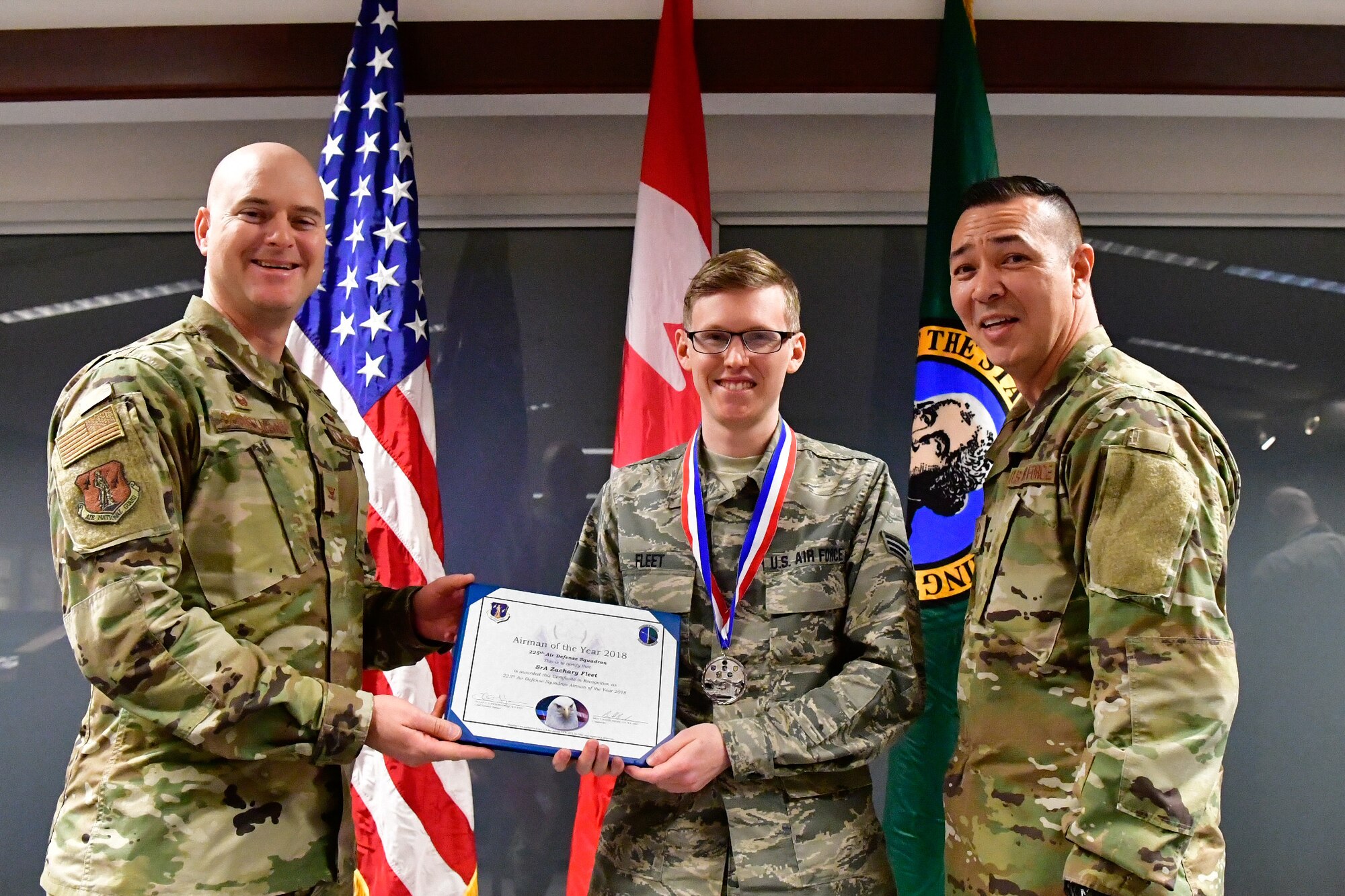 Senior Airman Zachary Fleet, 225th Air Defense Squadron interface control technician is named the 225th ADS Airman of the Year Dec. 1, 2018 on Joint Base Lewis-McChord.  Fleet poses with Col. Brett Bosselmann (left), 225th ADS commander and Chief Master Sgt. Allan Lawson, 225th ADS chief enlisted manager. (U.S. Air National Guard photo by Maj. Kimberly D. Burke)