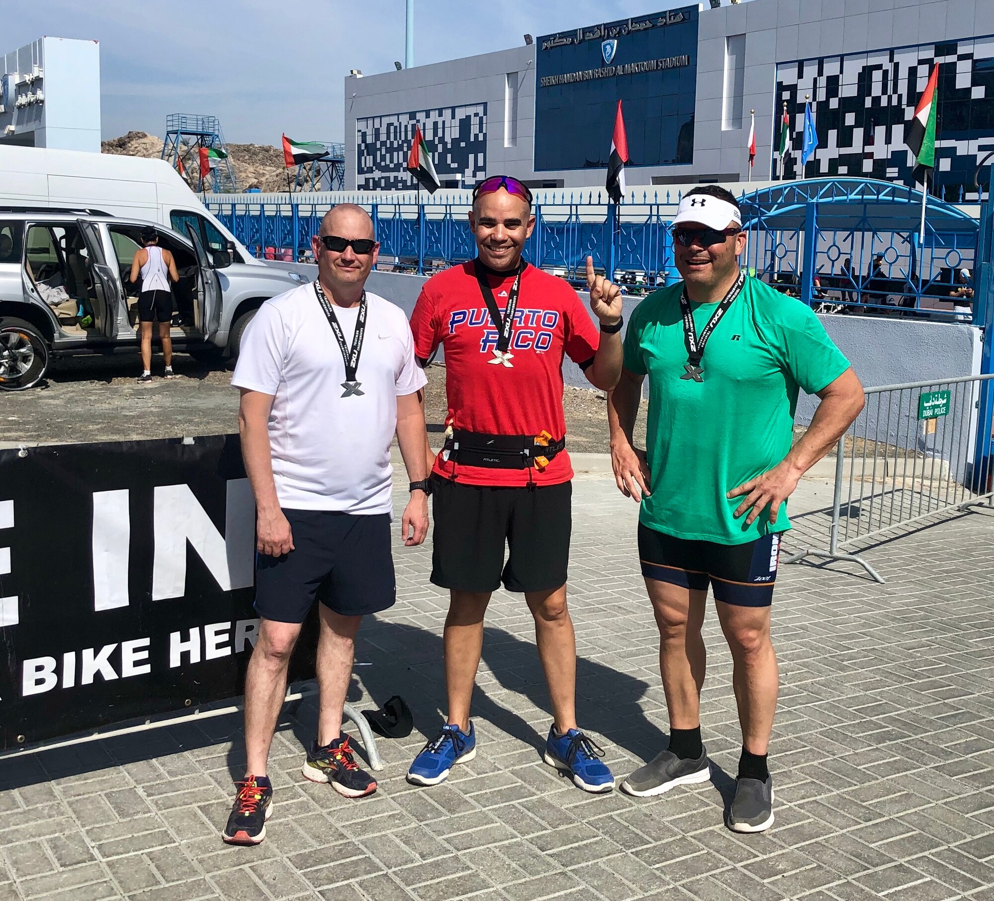 Lt Col. Dennis Knight, 380th Expeditionary Aircraft Maintenance Squadron commander (left), Lt Col. Alfredo Laboy, 380th Expeditionary Mission Support Group deputy commander (middle), and Lt Col Michael Bliss, 380th Expeditionary Maintenance Group deputy commander (right), pose for a photo after completing a racing event. All three members have challenged themselves to improving their physical fitness while deployed to Al Dhafra Air Base, United Arab Emirates. (Courtesy Photo)