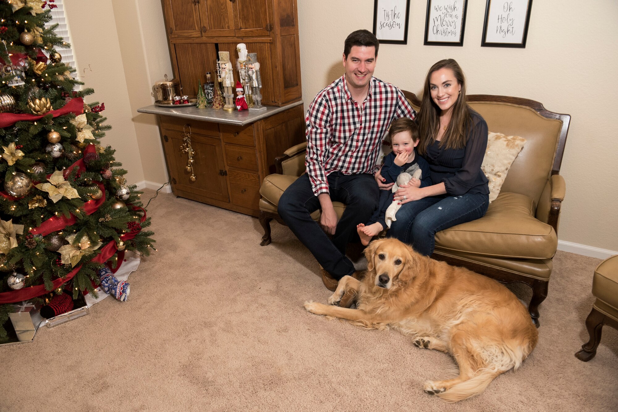 Capt. Steven Noller, 21st Airlift Squadron pilot, his spouse Morgan and their son Camden, pose for a family portrait in their home in Vacaville, California, Dec. 5, 2018. Morgan won the 2018 Joan Orr Air Force Spouse of the Year Award. (U.S. Air Force photo by Lan Kim)