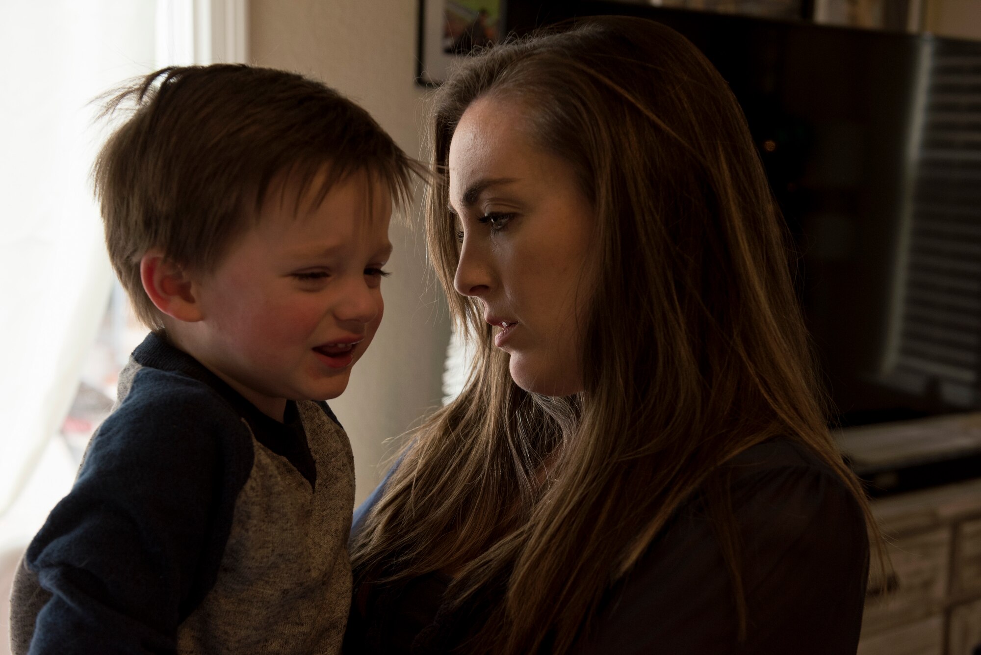 Morgan Noller comforts her son Camden at their home in Vacaville, California, Dec. 5, 2018. Noller won the 2018 Joan Orr Air Force Spouse of the Year Award. (U.S. Air Force photo by Lan Kim)