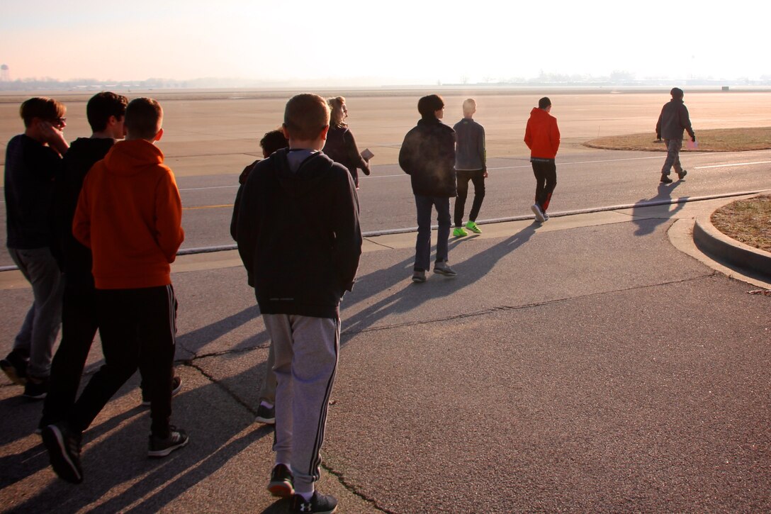 As part of a community outreach event, the 932nd Airlift Wing Maintenance Group's top officer and commander, Col. Sharon Johnson, at far right, leads a group of eighth grade Science, Technology, Engineering, and Mathematics (STEM) students along the flight line during a cool overcast morning visit December 10, 2018, at Scott Air Force Base, Illinois. Johnson's group of Airmen maintain four of the C-40 aircraft belonging to the 932nd AW and operated by the 932nd Operations Group and updated by the 932nd Maintenance Group, She and the public affairs officer escorted local Mascoutah students out to their hangar work center, to see more about how an airplane engine, wheels, tires, hydraulics, and wings work together and get a plane off the ground. Johnson and her maintainers manned informational stations as multiple groups of students rotated through various areas every 45 minutes at the reserve unit in southern Illinois near Belleville. (U.S. Air Force photo by Lt. Col. Stan Paregien)
