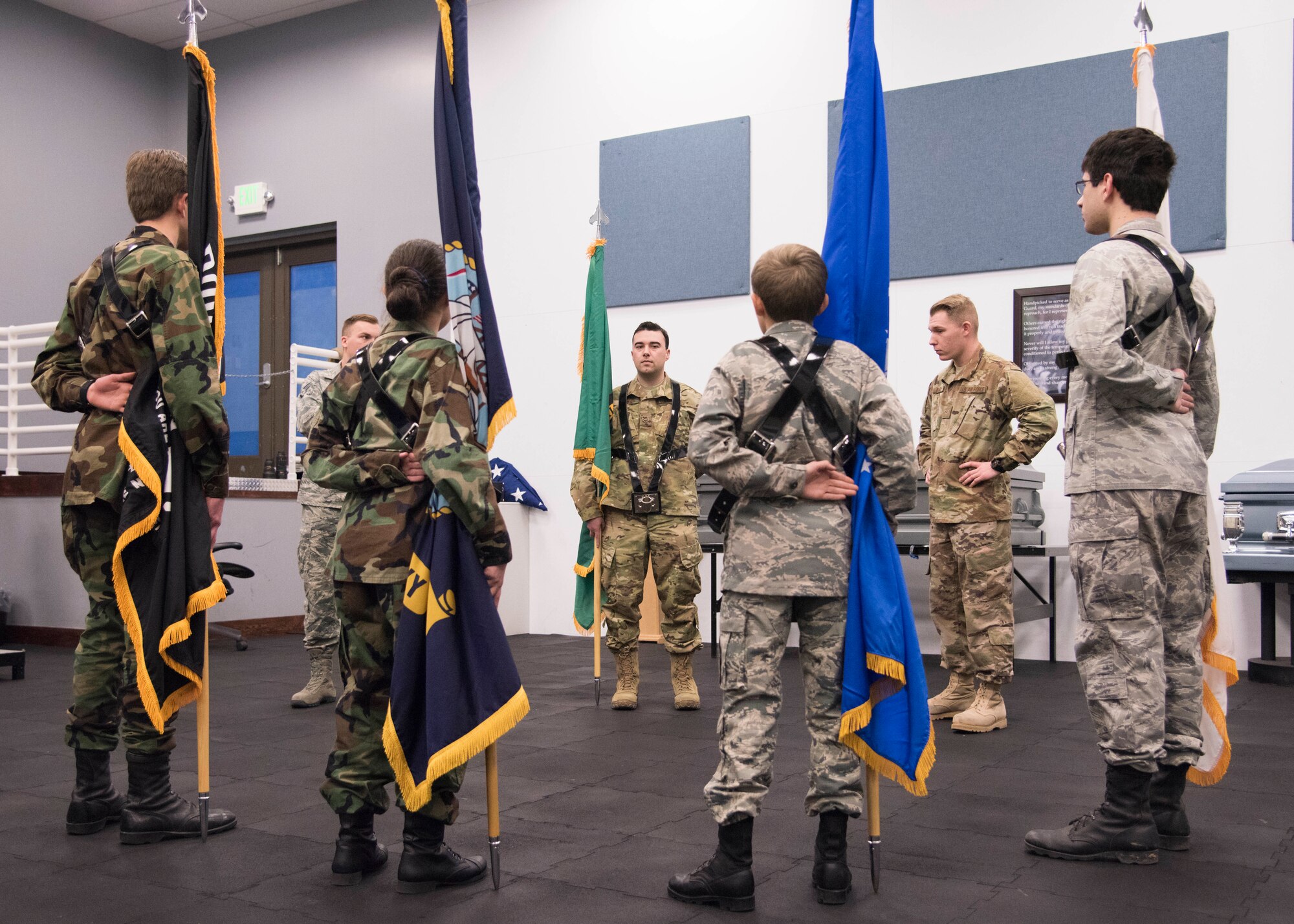 Team Fairchild Honor Guardsmen help four Civil Air Patrol Spokane Composite Squadron cadets train with flags at Fairchild Air Force Base, Washington, Nov. 26, 2018. CAP is a volunteer organization that performs three congressionally assigned key missions: emergency services, disaster relief operations and aerospace education for youth and the general public. (U.S. Air Force photo by Senior Airman Ryan Lackey)
