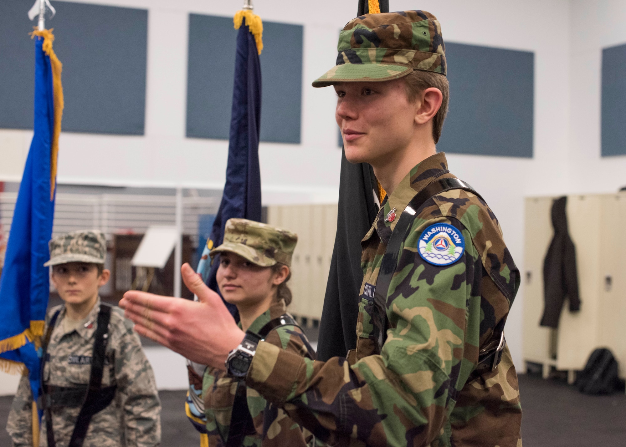 Noah Booz, Civil Air Patrol Spokane Composite Squadron cadet, poses a question about "presenting colors" while training with Honor Guardsmen at Fairchild Air Force Base, Washington, Nov. 26, 2018. Team Fairchild Honor Guardsmen serve four month-long terms and have a full schedule of ceremonies to perform for and are encouraged to do volunteer work if time allows. (U.S. Air Force photo/Senior Airman Ryan Lackey)