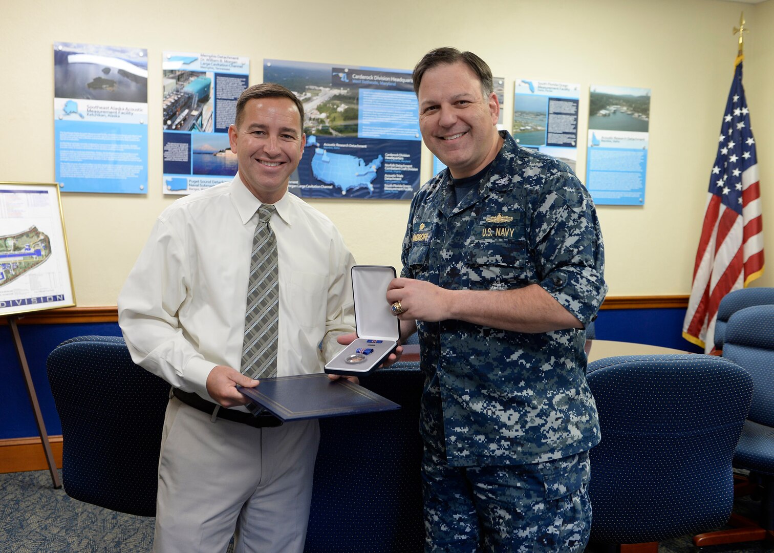 Brian Caine, TUBA Technical Program Manager, receives the Navy Meritorious Civilian Service Award on Nov. 7, 2018, from Naval Surface Warfare Center, Carderock Division Commanding Officer Capt. Mark Vandroff for his contributions in the area of acoustics systems for undersea warfare. (U.S. Navy photo by Devin Pisner/Released)