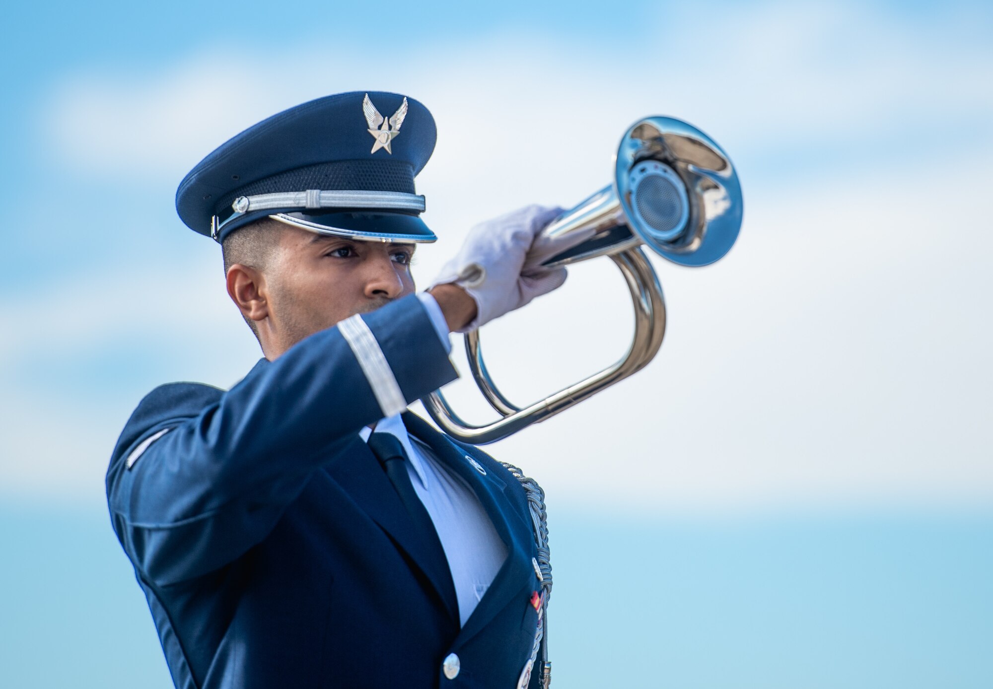 A Luke Air Force Base honor guardsman plays Taps during a memorial service for Capt. Stephen “Trip” Grace Dec. 7, 2018, at Luke Air Force Base, Ariz. Airmen from across Luke paused to honor and celebrate the life of Capt. Grace. (U.S. Air Force photo by Senior Airman Alexander Cook)