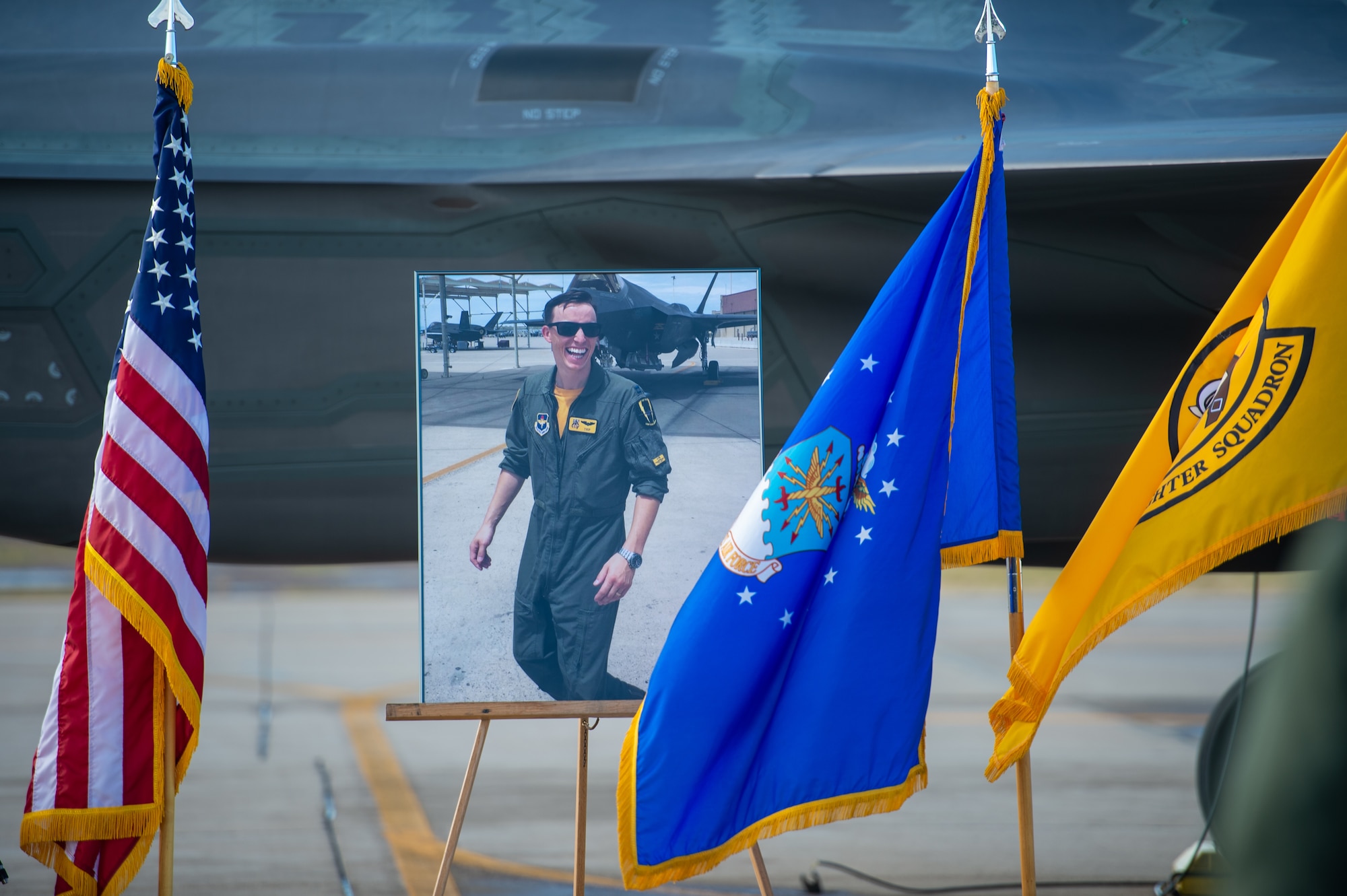 A picture of Capt. Stephen “Trip” Grace is displayed during a memorial service Dec. 7, 2018, at Luke Air Force Base, Ariz. Capt. Grace was assigned to the 61st Fighter Squadron and was recognized as the Company Grade Officer of the Year in 2018. (U.S. Air Force photo by Senior Airman Alexander Cook)