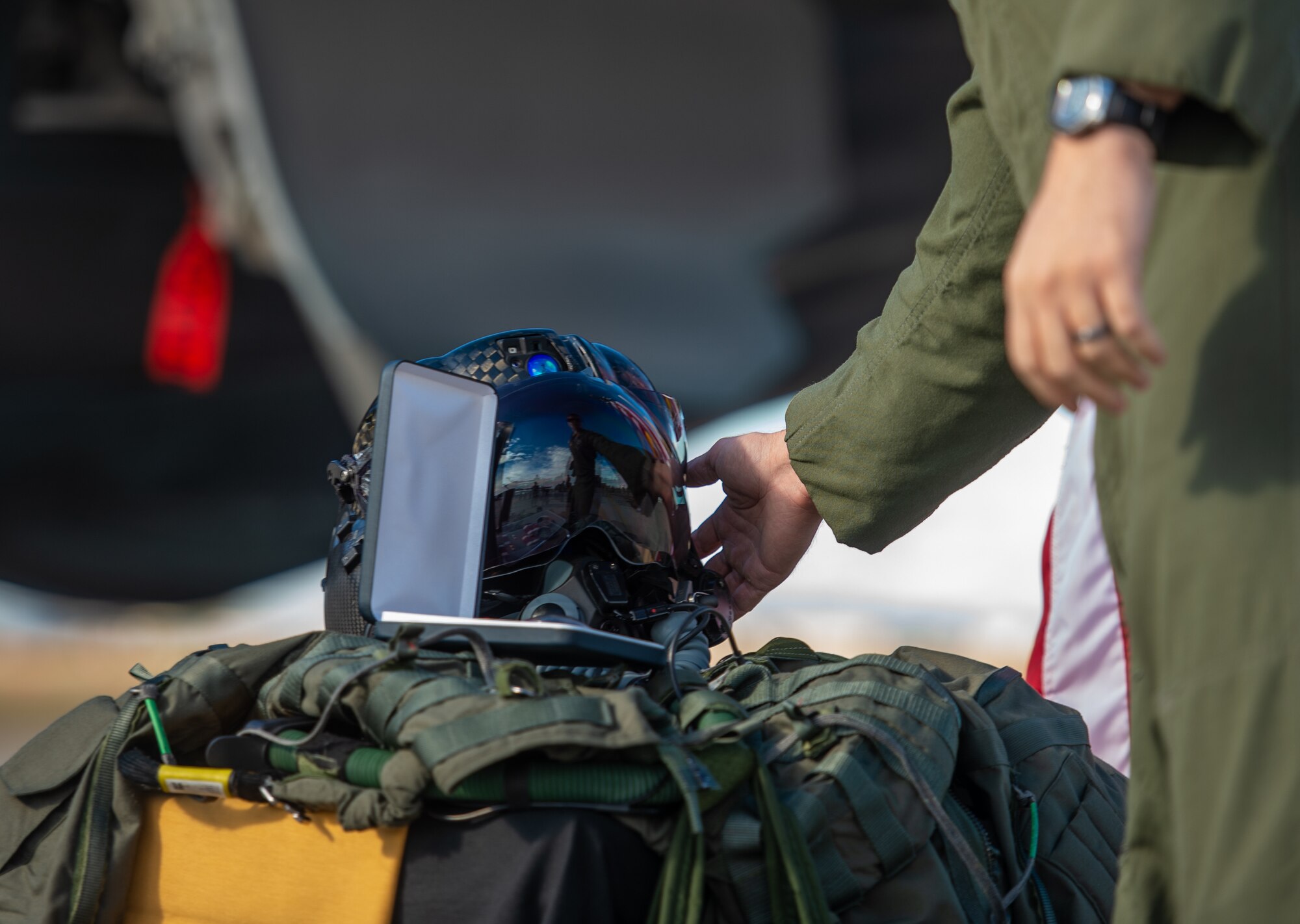 A fighter pilot touches Capt. Stephen “Trip” Grace’s F-35 helmet during his memorial service Dec. 7, 2018, at Luke Air Force Base, Ariz. Numerous family members and friends were in attendance to honor and celebrate the life of Capt. Grace. (U.S. Air Force photo by Senior Airman Alexander Cook)