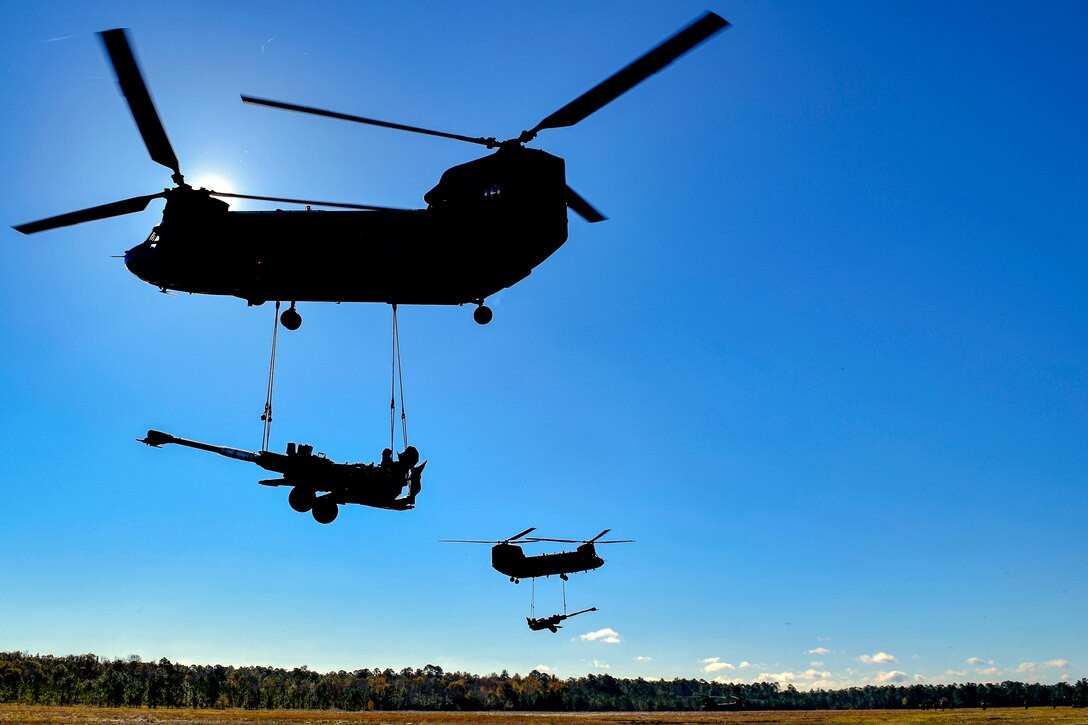 Helicopters carry large howitzer guns.