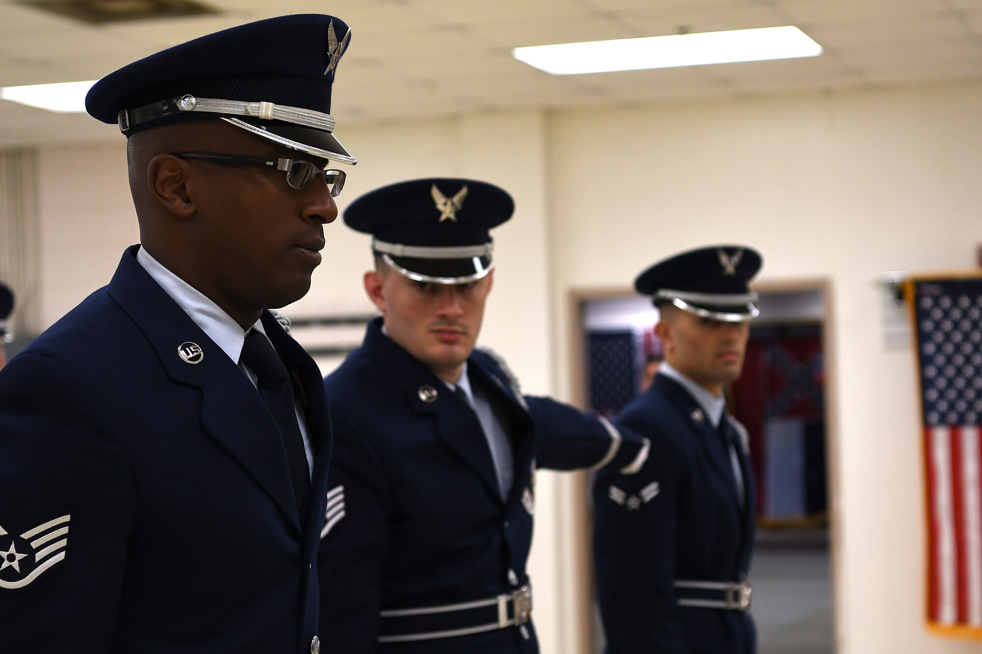U.S. Air Force Staff Sgt. Michael Williams, Staff Sgt. Dalton Kirby, and Airman 1st Class Brandon Ahuna, Keesler Air Force Base Honor Guard members, participate in an open ranks inspection inside the honor guard building at Keesler Air Force Base, Mississippi, Nov. 29, 2018. Honor guard members practice four out of five working days to execute precise movements for future details. (U.S. Air Force photo by Airman 1st Class Suzie Plotnikov)