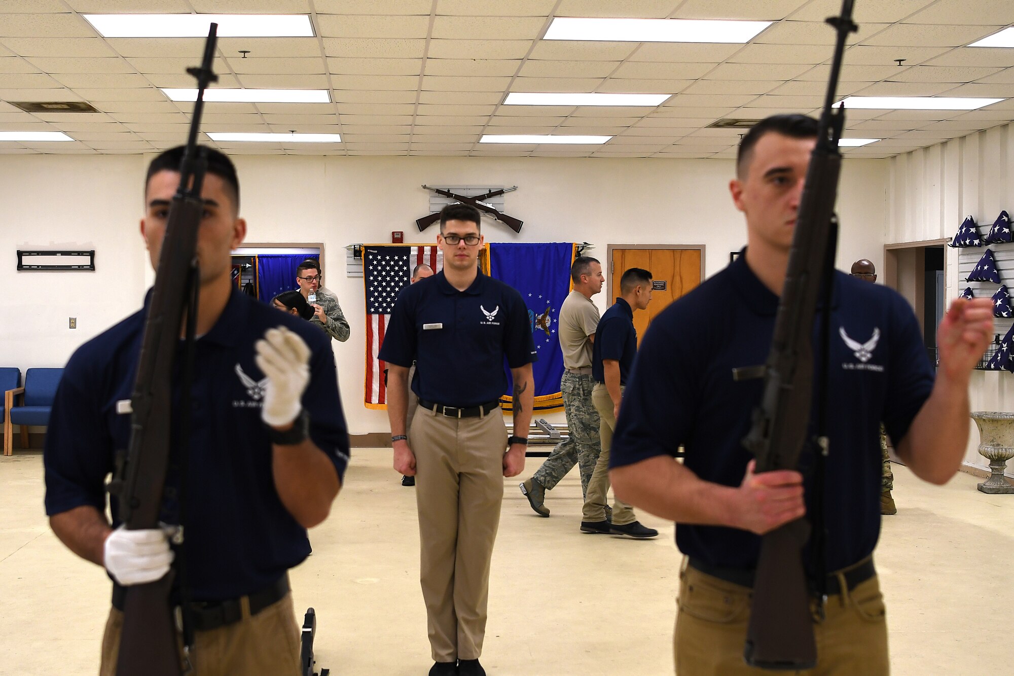 U.S. Air Force Airman 1st Class Brandon Ahuna, Senior Airman Frederick Taylor and Airman 1st Class Miklo Miller, Keesler Air Force Base Honor Guard members, practice rifle movements inside the honor guard building at Keesler Air Force Base, Mississippi, Nov. 29, 2018. Honor guardsmen practice four out of five working days to execute precise movements for future details. (U.S. Air Force photo by Airman 1st Class Suzie Plotnikov)