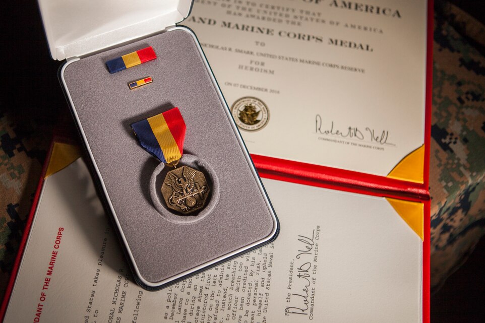 The Navy and Marine Corps Medal and citation are posthumously awarded to Lance Cpl. Nicholas R. Smarr, a Reserve Marine killed in the line of duty while serving as a police officer for the Americus Police Department in Americus, Ga., Dec. 7, 2018. The Navy and Marine Corps Medal is the highest non-combat decoration awarded for heroism by the Department of Defense. (U.S. Marine Corps photo by Cpl. Niles Lee)