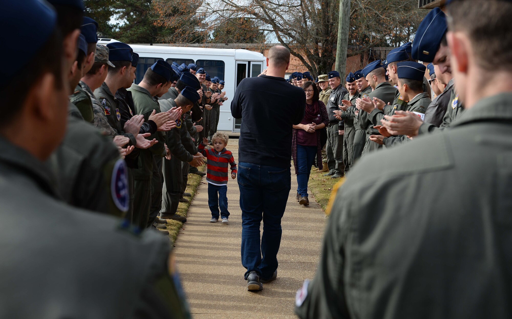 Pilots from the 41st Flying Training Squadron welcome Tobias Taylor, Pilot for a Day, and his family, Dec. 6, 2018, on Columbus Air Force Base, Mississippi. Pilot for a Day is a program where medically disabled youth get a “red carpet day” custom-tailored to their desires and capabilities. (U.S. Air Force photo by Airman Hannah Bean)