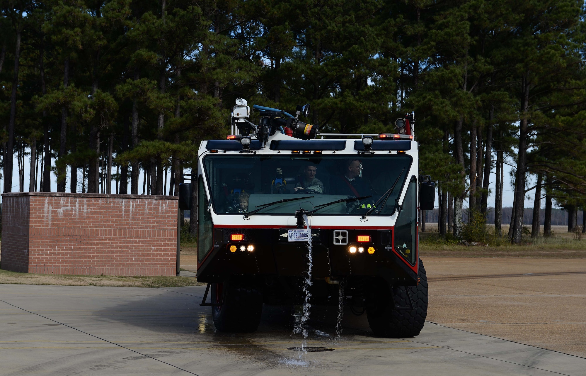 Tobias Taylor, Pilot for a Day, and Clay Taylor, Tobias’ father, ride in a firetruck with Airman 1st Class Michael Findlay, 14th Civil Engineer Squadron firefighter, Dec. 6, 2018, on Columbus Air Force Base, Mississippi. Tobias, a 5-year-old boy who suffers from cystic fibrosis, spent the day experiencing life as a pilot in the U.S. Air Force (U.S. Air Force photo by Airman Hannah Bean)