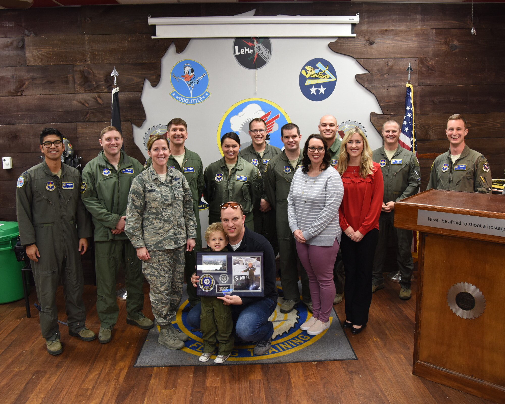 Tobias Taylor, Pilot for a Day, and his family pose with members of Team BLAZE and local business leaders Dec. 6, 2018, on Columbus Air Force Base, Mississippi. Pilot for a Day is a program where medically disabled youth get a “red carpet day” custom-tailored to their desires and capabilities. (U.S. Air Force photo by Melissa Doublin)
