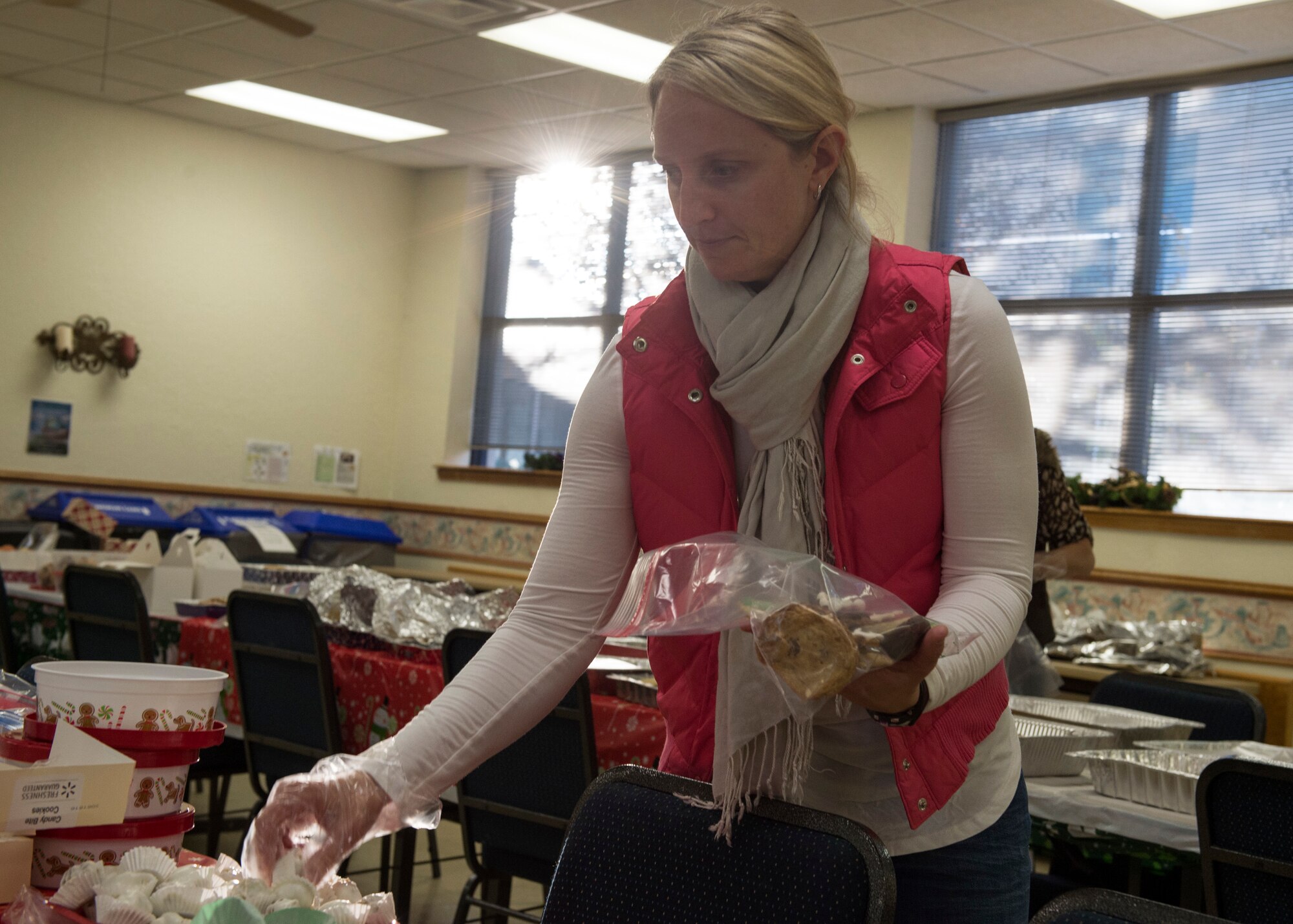 Kelli Thomas, spouse of U.S. Air Force Col. Steven Thomas, 97th Civil Engineer Squadron commander, places cookies in a bag, Dec. 11, 2018, at Altus Air Force Base, Okla.