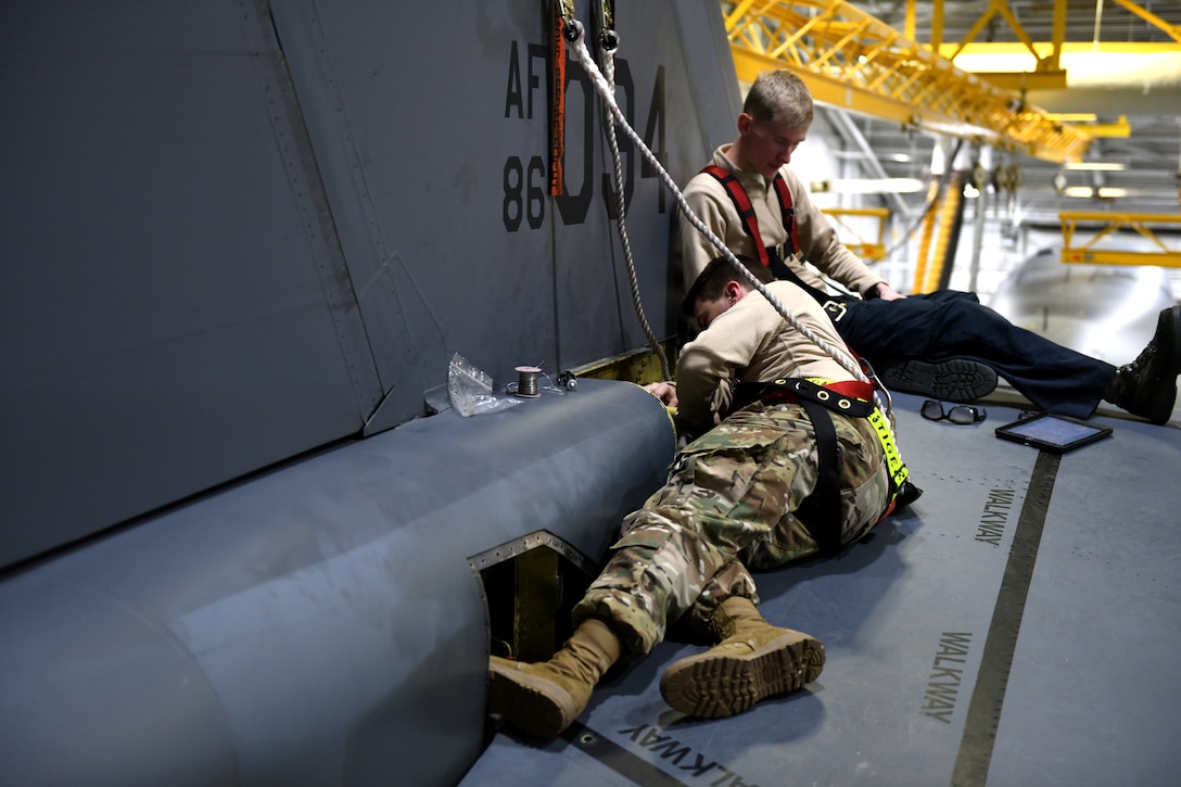 Staff Sgt. Ryan Petroski, a 28th Aircraft Maintenance Squadron hydraulic systems craftsman, right, and Senior Airman Dalton Christopherson, a 28th AMXS hydraulic systems apprentice, left, inspect the right-side actuator on a B-1B Lancer at Ellsworth Air Force Base, S.D., Dec. 4, 2018. Hydraulic systems Airmen are responsible for any air, gas or fluid-pressurized components on the aircraft. (U.S. Air Force photo by Senior Airman Denise Jenson)